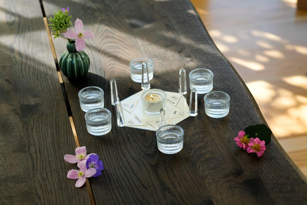 Tameana therapy setup with quartz crystals, a glass of water and light for a remote energy treatment.